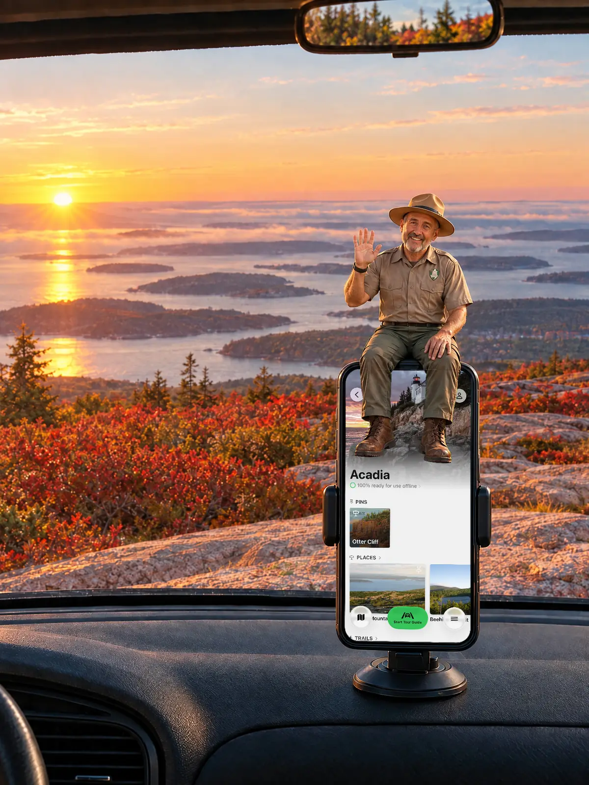 The Parkwolf tour guide waving from a dashboard phone at sunrise on Cadillac Mountain