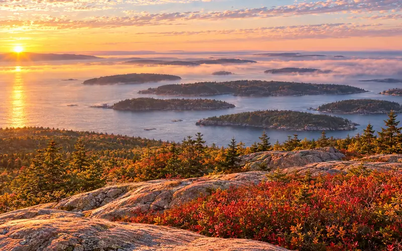 Sunrise over Frenchman Bay from Cadillac Mountain's pink granite summit