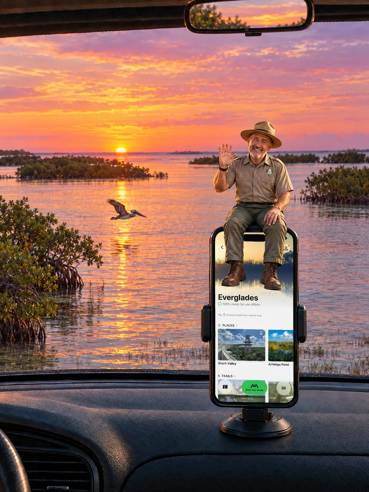 The Parkwolf tour guide waving from a dashboard phone at sunset over Florida Bay and the mangrove islands at Flamingo
