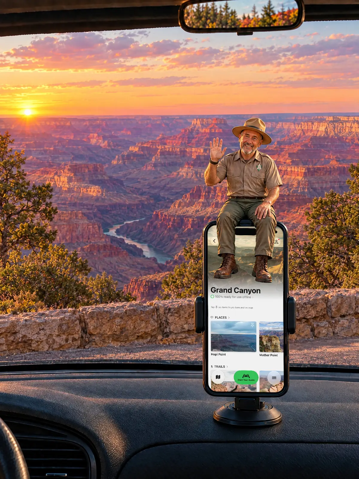 The Parkwolf tour guide waving from a dashboard phone at sunset over the Grand Canyon and the Colorado River