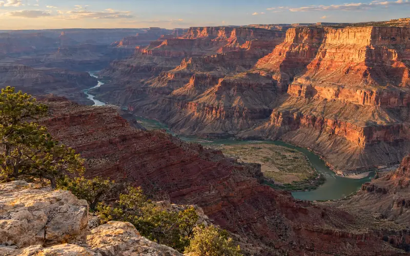 The Colorado River bending around the Unkar Delta far below Lipan Point in late-afternoon light