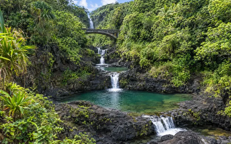 Tiered waterfalls and pools of ʻOheʻo Gulch in Kīpahulu, flowing toward the ocean